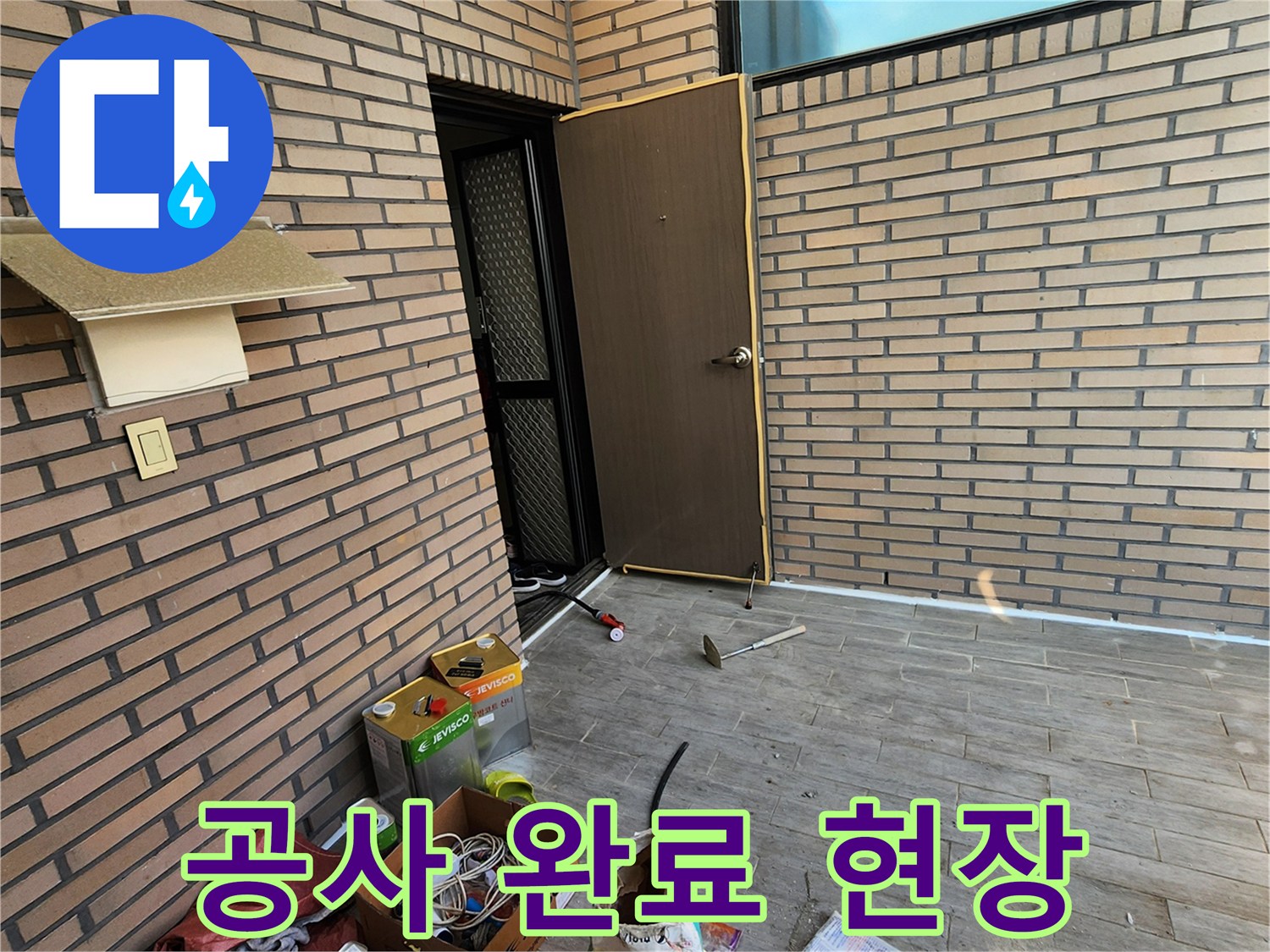정리 중인 공사 자재와 벽돌 외벽의 모습
