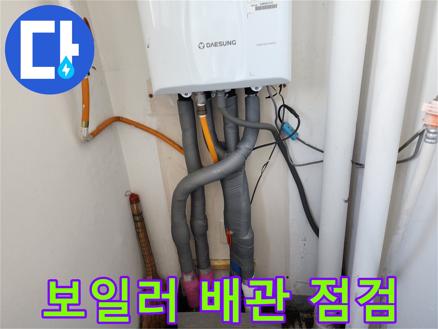 회색 보온재와 노란색 배관이 섞인 보일러 하단부