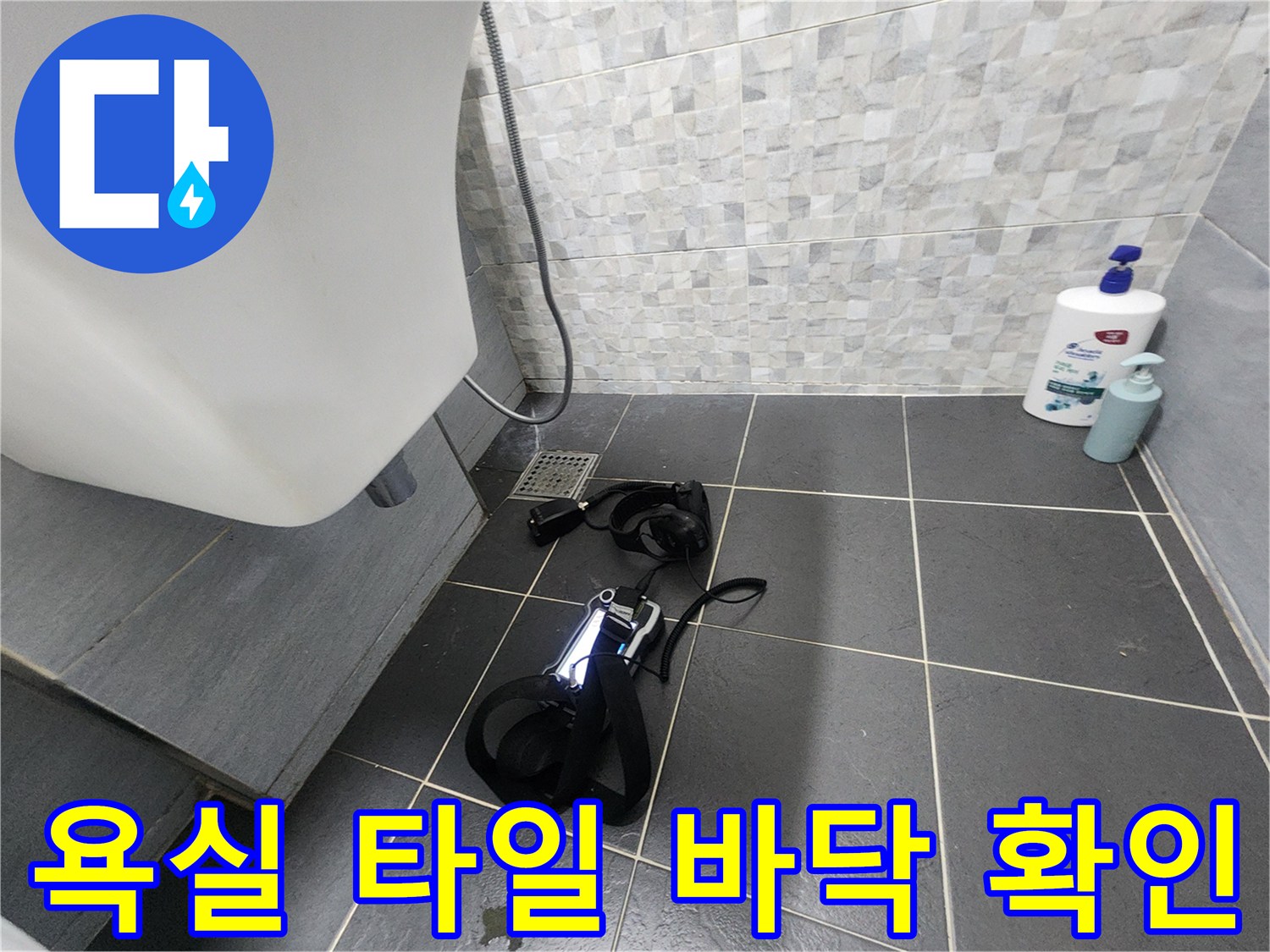 회색 타일 바닥과 배수구 주변의 현장 사진