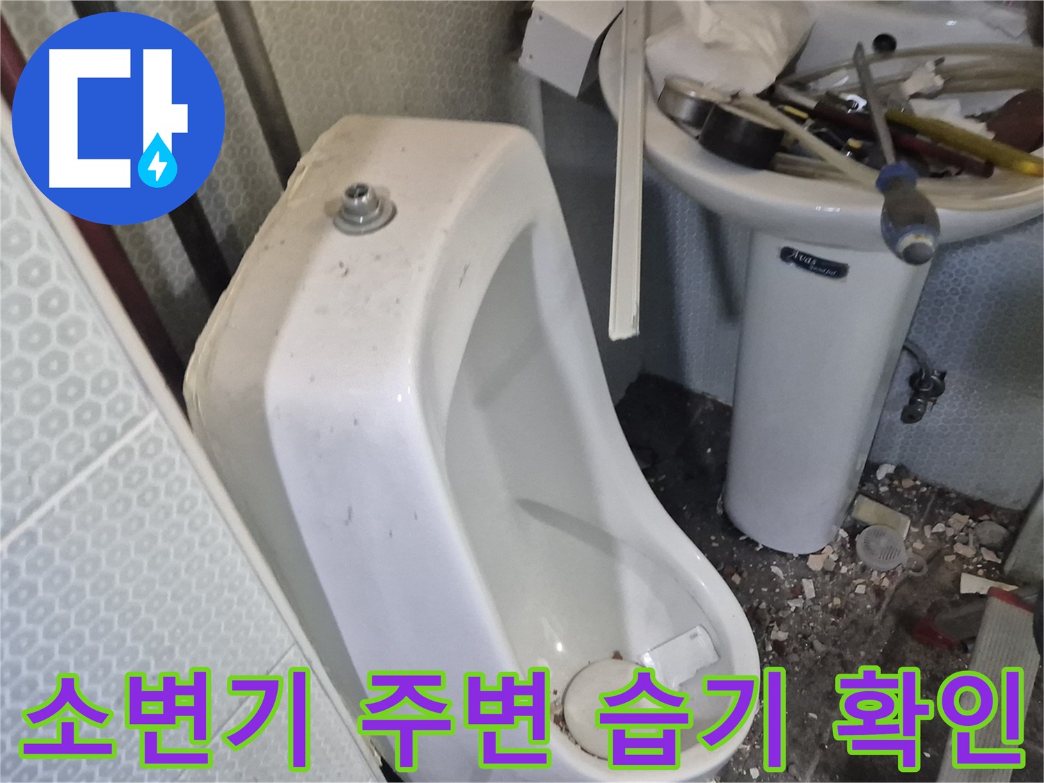 축축하게-젖어있는-소변기-뒷벽-타일-모습