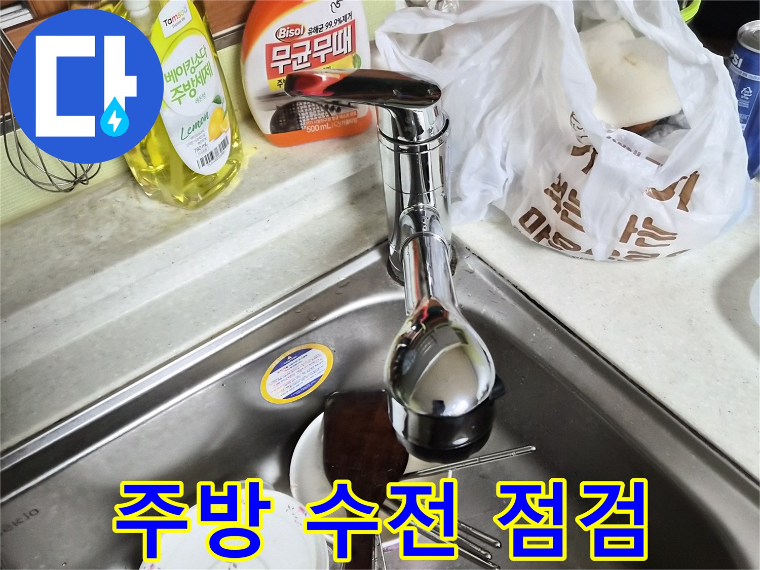 누수가 의심되는 싱크대 수전과 세척 용품들