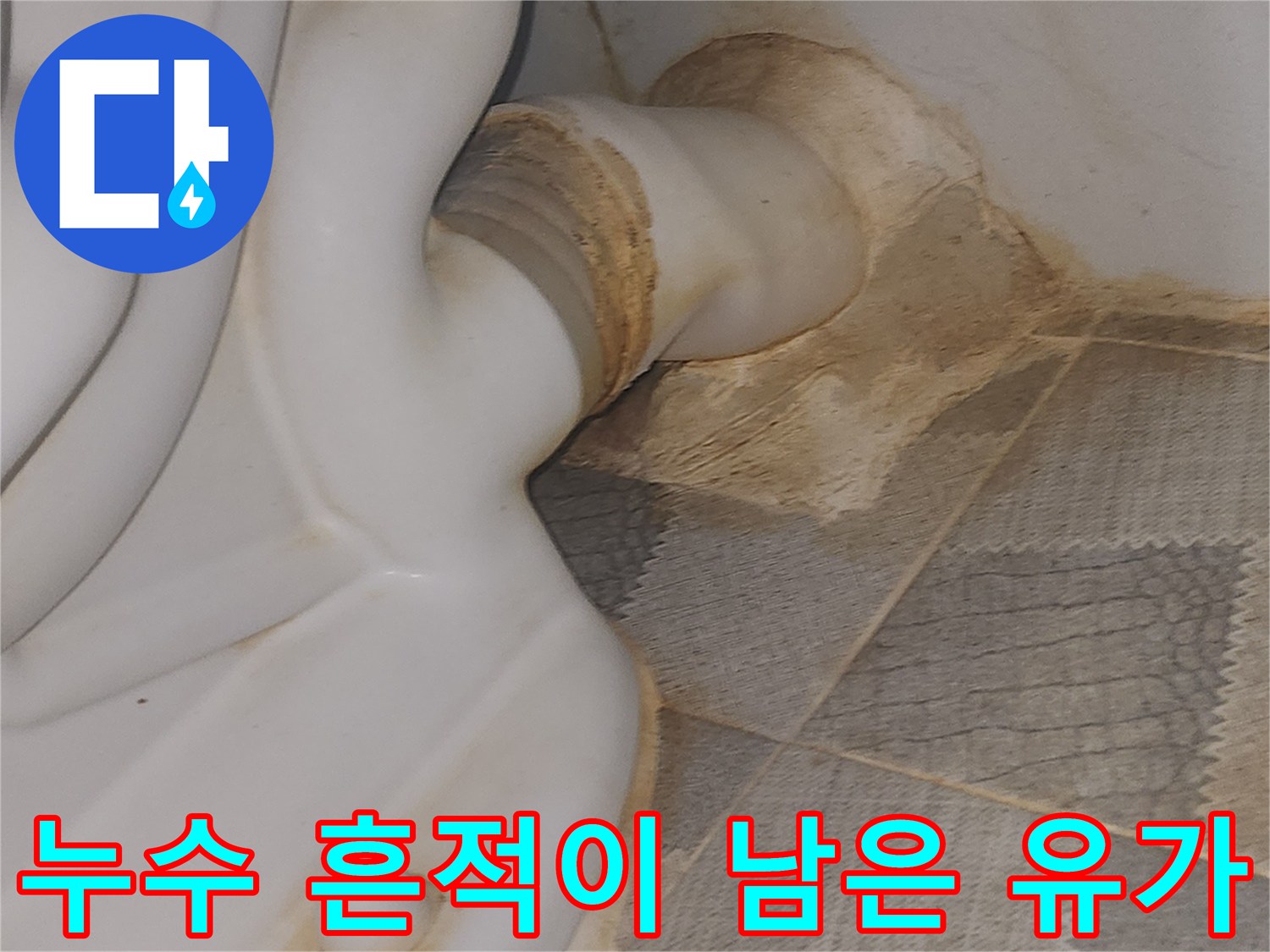 화장실 배수구 주변 타일의 갈색 누수 자국