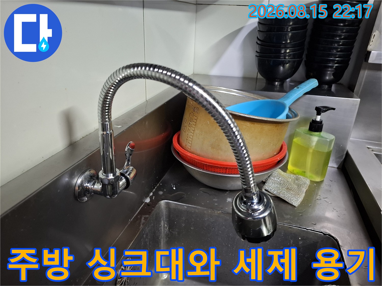 싱크대 옆의 액체 세제와 배수용 그릇들입니다.