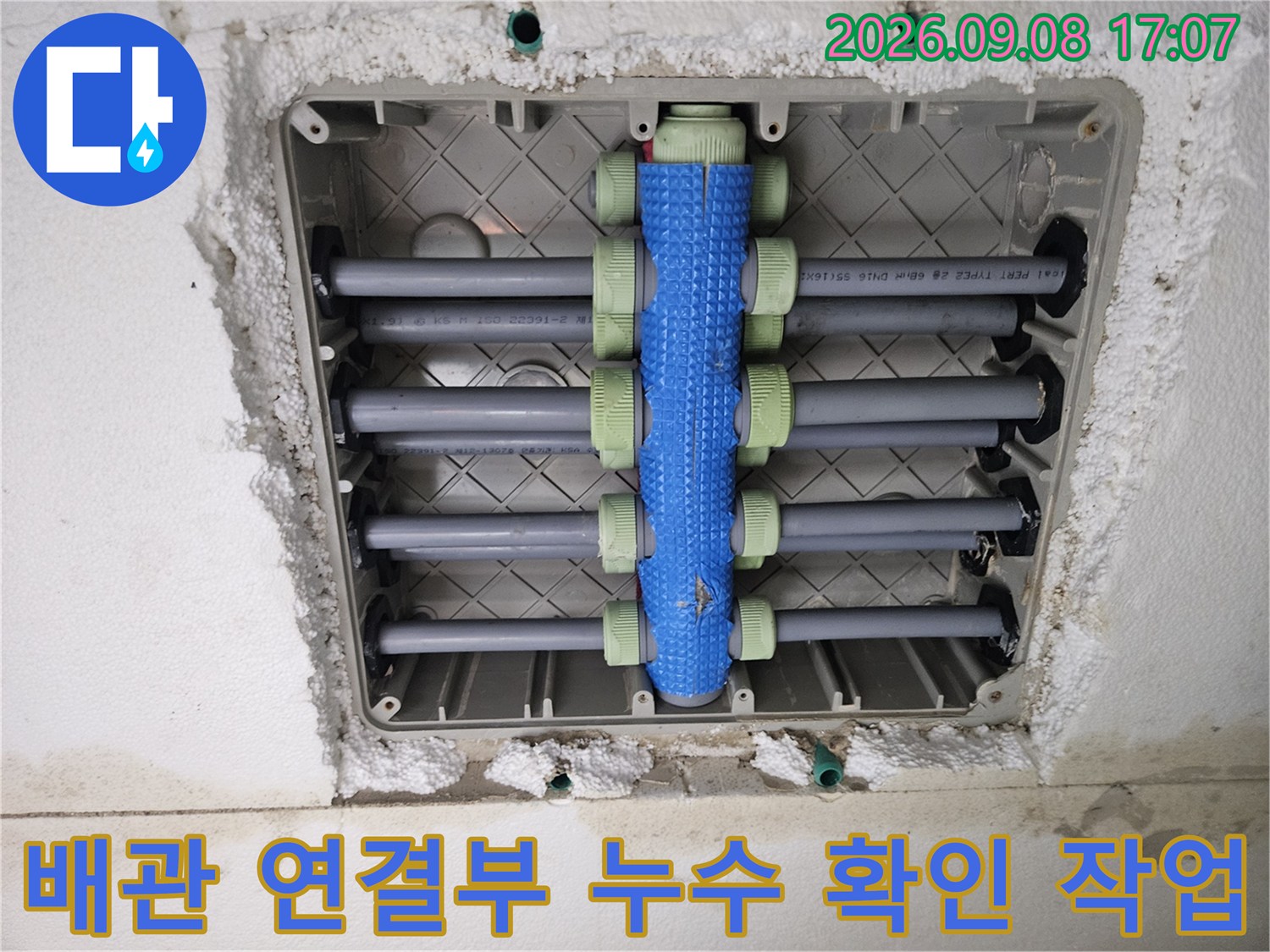 회색 배관과 파란색 분배기가 결합된 매립 배관의 상세 구조 사진